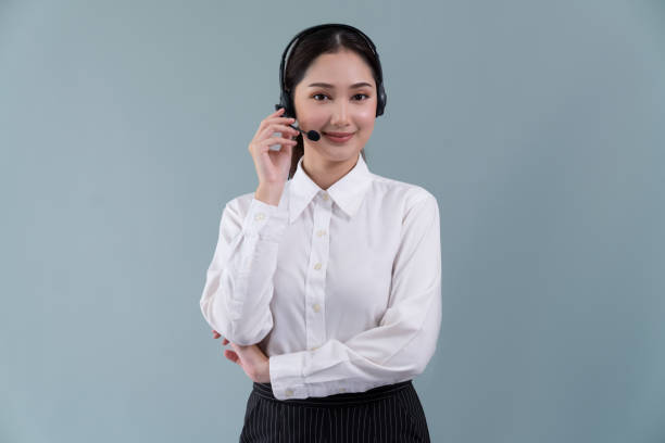 istock Attractive Asian operator with formal suit and headset. Enthusiastic 1487458939