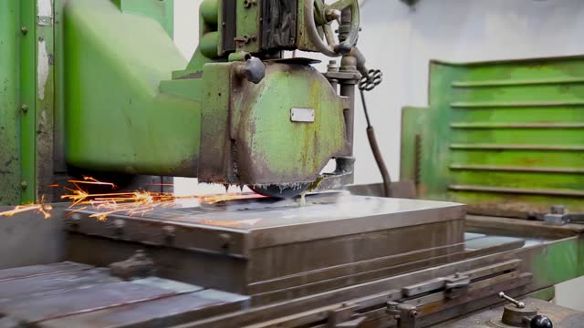 View of CNC Milling Machine Produces Metal Detail on Factory using liquid