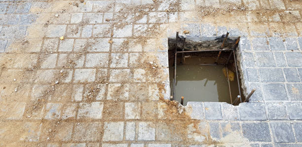 istock Worker or labor digging hole for installation pillar or pole on cement ground with copy space 1487459185