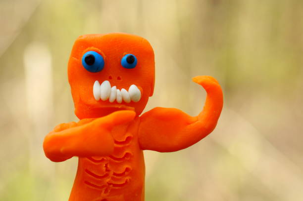 The toy zombie points to the arm muscles.