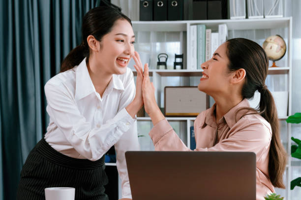 istock Colleagues in the office workspace give high-five. Enthusiastic 1487460777