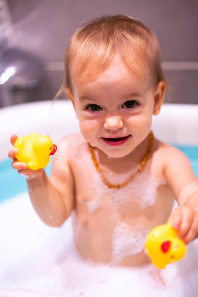 istock Happy baby girl is having a bath 1487461229