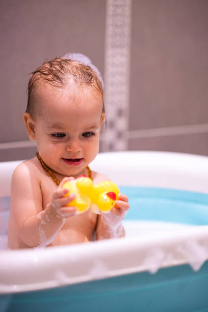 istock Happy baby girl is having a bath 1487461274