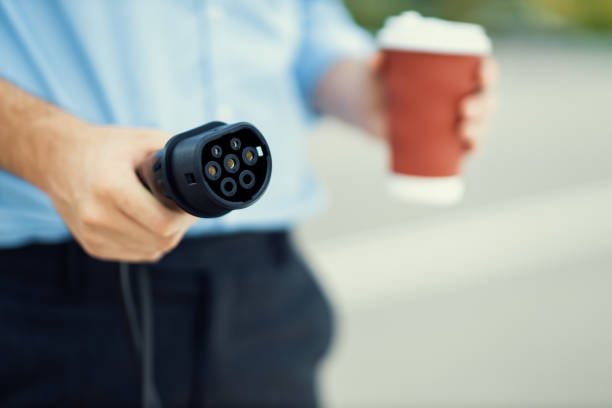 istock Focus progressive EV charger device pointing at camera with blur background. 1487462245