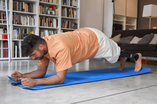 istock Amputee man with prosthetic leg prosthesis doing plank exercise. 1487463878