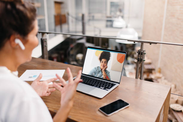 istock Small business owner having a video call in a warehouse 1487464024