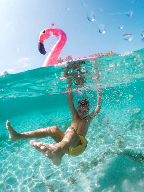 istock Child Having Fun In Crystal Clear Sea Water 1487466794