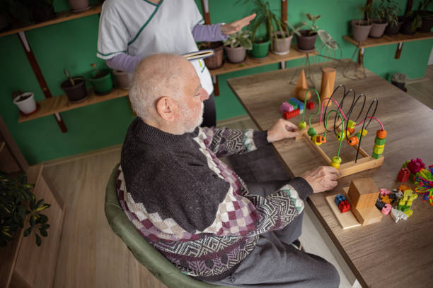 istock Colorful toy therapy session helps senior man 1487467974
