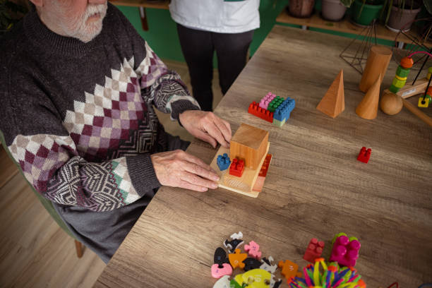 istock Toy therapy session with nurse helps senior man with dementia 1487468253
