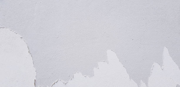 istock White painted cracked on gray cement wall for background with copy space 1487468936