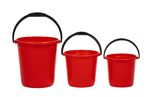 empty red plastic household bucket on a white background