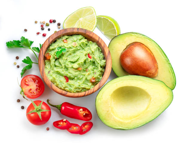 istock Guacamole bowl and guacamole ingredients isolated on white background. Flat lay. 1487469829