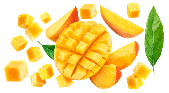 Mango fruit slices and mango cubes flying isolated on white background.