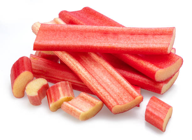 istock Red rhubarb stems' cuts isolated on white background. 1487470012