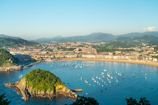 San Sebastian, SPAIN - July 09 2022: High angle view of San Sebastian - Donostia city at sunset. Situated in north of Spain, Basque Country. Famous travel destination. View of La Concha Bay