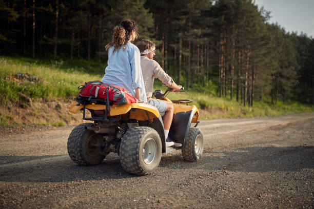 istock Two enthusiastic friends driving quad together 1487472115