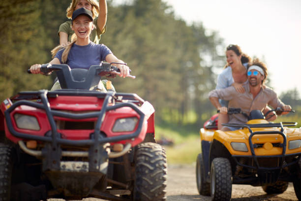 istock Young people ride quads on a road in the nature. 1487472448