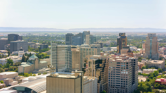 Aerial view of modern skyscrapers in city during sunny day, Sacramento, California, USA.