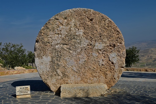 A view of a rolling stone. An ancient fortified door on display at Mount Nebo in Jordan.