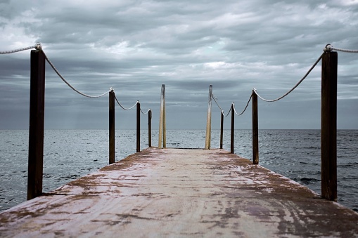 A picturesque scene of a wooden dock, with a sturdy chain securely tied to both ends
