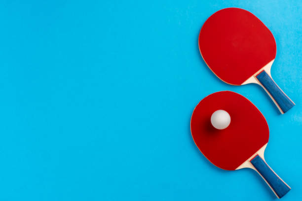 istock Ping pong racket and ball on blue background 1487477363