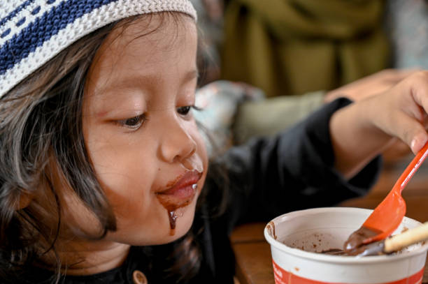 istock Asian toddler eating chocolate ice cream 1487477456