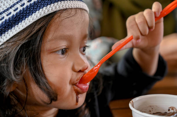 istock Asian toddler eating chocolate ice cream 1487477458