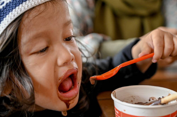 istock Asian toddler eating chocolate ice cream 1487477645