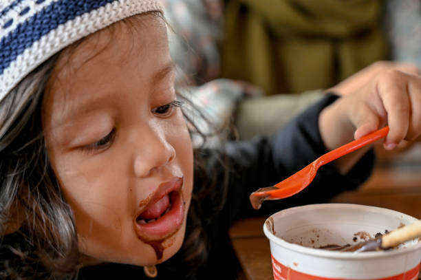 istock Asian toddler eating chocolate ice cream 1487477647