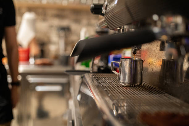 istock Coffee pouring into a cup out of an espresso machine 1487477785