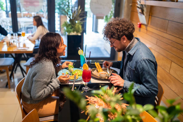 istock Couple eating and talking in a restaurant 1487477786