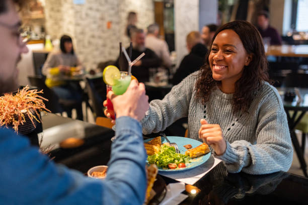 istock Couple proposing a toast while eating in a restaurant 1487478074