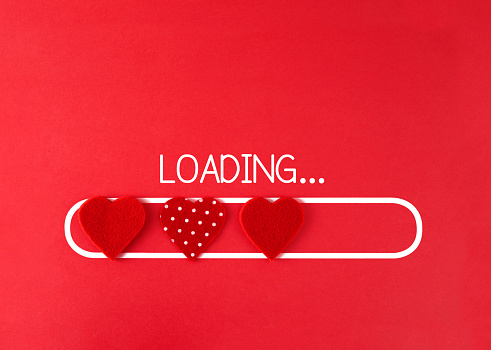 Loading text with hearts on a pink background