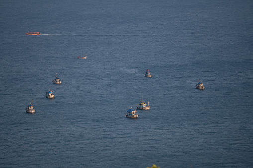 Full frame shot of fishing boats in the Arabian sea at Goa in India. Boats as seen from the top of the hill in Goa. Fishing boats in the sea. Boats fishing in the Arabian sea.