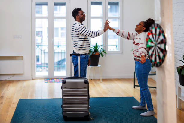istock A young African couple is preparing a suitcase for a vacation. 1487479716