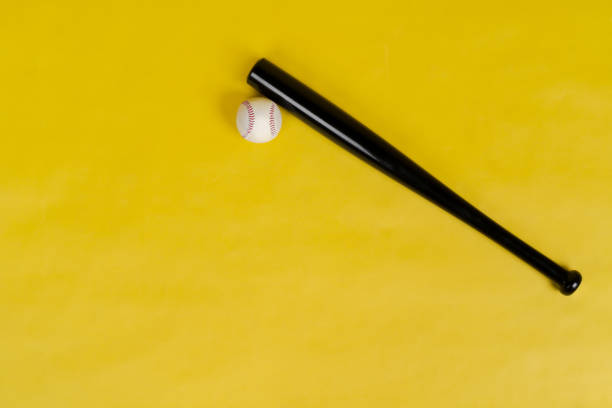 istock Baseball bat and ball on bright yellow background 1487479760