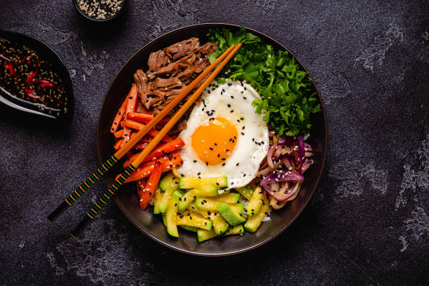 istock Traditional Korean dish Bibimbap: rice with vegetables beef and egg. 1487481060