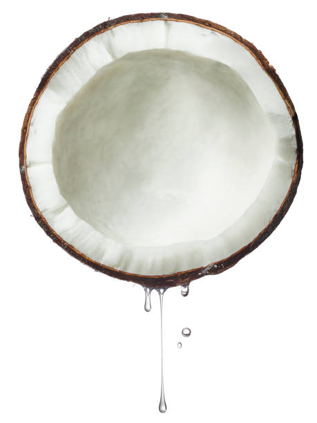 istock Coconut split in half with extract or coconut oil dripping. 1487481499