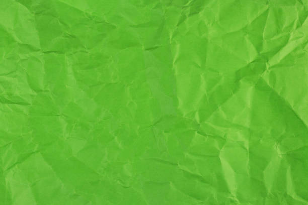 istock Green clumped paper texture background, carft paper board wrinked and rough material, 1487482692