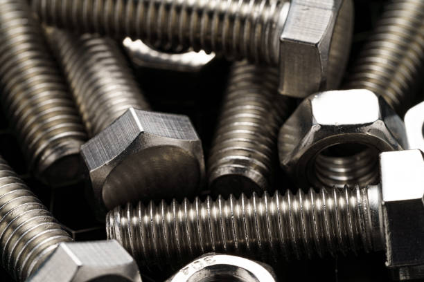 istock Steel nuts and bolts closeup on dark background 1487483730