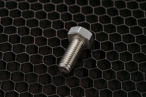 Steel bolt closeup on dark background