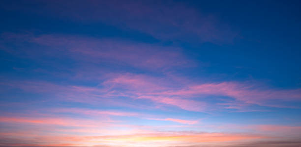 istock Beautiful Romantic Orange Sunset Clouds with sunlight on Dusk Sky Twilight background in Panoramic view 1487484850
