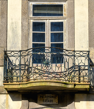 Window and balcony. A sign reads \