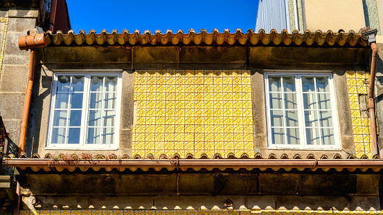 Old facade with yellow tiles
