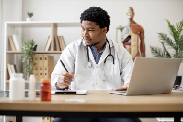 istock Physician typing on laptop and making notes in clinic 1487486227