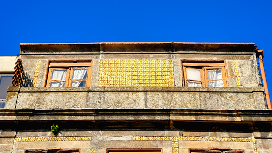 Old facade with yellow tiles
