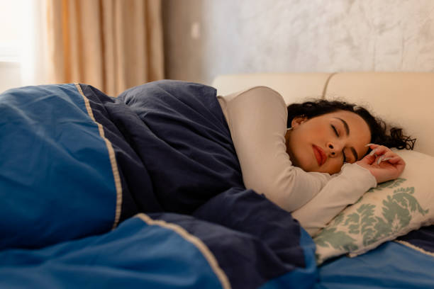 istock A young woman in bed under a blanket is sleeping and relaxing. 1487486658