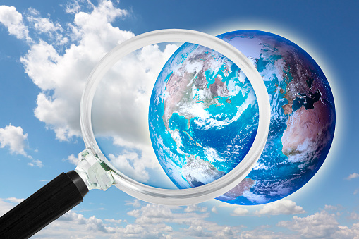 Looking at planet earth towards USA - Concept seen through a magnifying glass with elements furnished by NASA