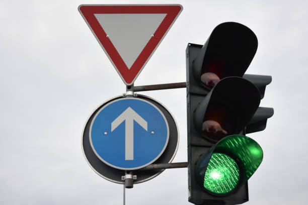 istock A traffic light with a green enabling light on and traffic control signs next to it 1487490053