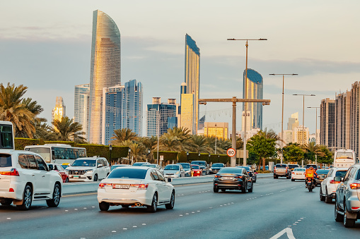 15 January 2023, Abu Dhabi, UAE: view of a wide street with busy car traffic among skyscrapers with hotels and residential real estate blocks